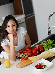 Image showing Young Woman Cooking in the kitchen