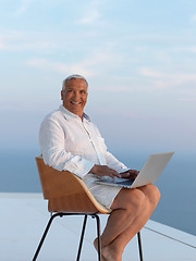 Image showing relaxed senior man on balcony