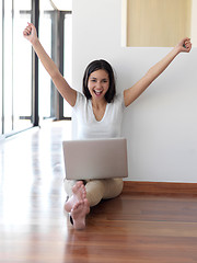 Image showing relaxed young woman at home working on laptop computer