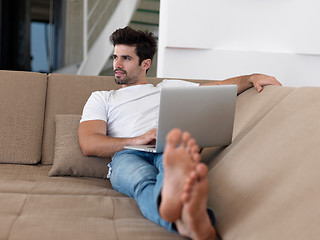 Image showing Man Relaxing On Sofa With Laptop