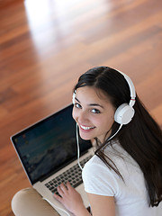 Image showing relaxed young woman at home working on laptop computer