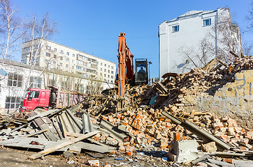 Image showing Excavator loads garbage from demolished house