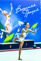 Image showing Young attractive girl shows exercise with ball