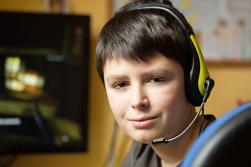 Image showing Boy using computer at home, playing game