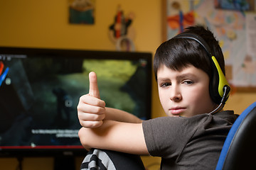 Image showing Boy using computer at home, playing game