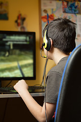 Image showing Boy using computer at home, playing game