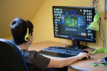 Image showing Boy using computer at home, playing game