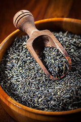 Image showing Dry tea in a wooden bowl