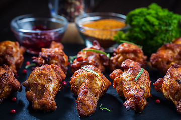 Image showing BBQ chicken wings with spices and dip