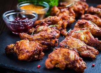 Image showing BBQ chicken wings with spices and dip