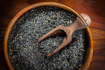 Image showing Dry tea in a wooden bowl