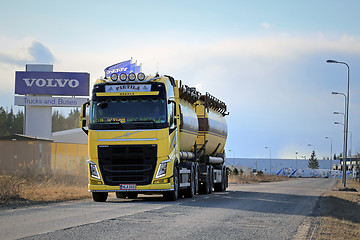 Image showing Yellow Volvo FH Tank Truck on the Road with Volvo Trucks Sign