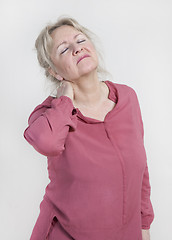 Image showing Woman holding his neck