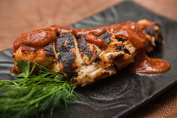 Image showing the cut chicken fillet baked in spices and tomato sauce