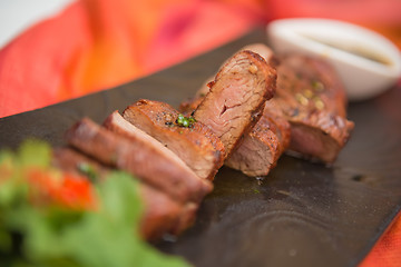 Image showing organic fresh ripe roasted beef meat with sauce