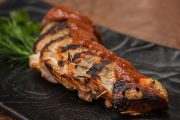 Image showing the cut chicken fillet baked in spices and tomato sauce