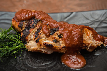 Image showing the cut chicken fillet baked in spices and tomato sauce