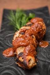 Image showing the cut chicken fillet baked in spices and tomato sauce