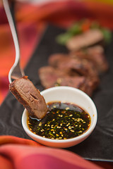 Image showing organic fresh ripe roasted beef meat with sauce