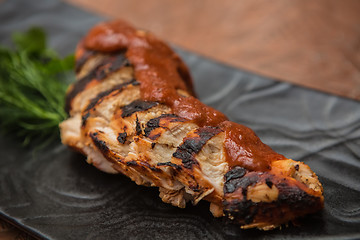 Image showing the cut chicken fillet baked in spices and tomato sauce