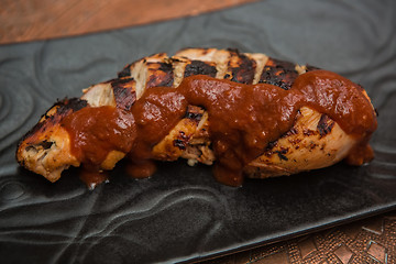 Image showing the cut chicken fillet baked in spices and tomato sauce