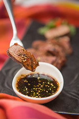 Image showing organic fresh ripe roasted beef meat with sauce