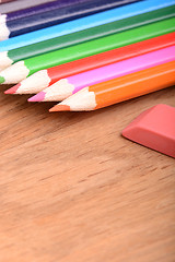 Image showing pencil set on wooden plate with eraser