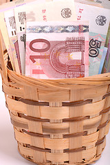 Image showing money set in a basket, dollars, euro and ukrainian money