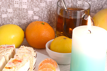 Image showing sweet cake on white plate with fruits and candle