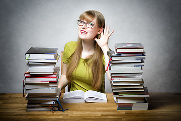 Image showing Listening female student with books
