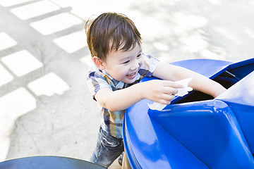 Image showing Cute Mixed Race Boy Placing Paper Into Recycle Bin