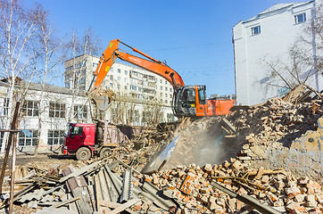 Image showing Excavator loads garbage from demolished house