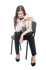 Image showing Pretty businesswoman with roubles sits on chair