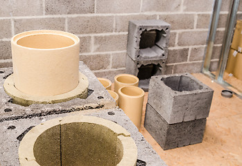 Image showing Construction of modular ceramic chimney in the house