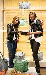 Image showing Two young girls shopping for handbags