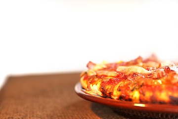 Image showing pizza on the brown plate, isolated