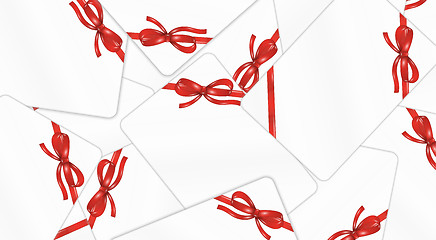 Image showing mess of white gift cards with red ribbon and bow