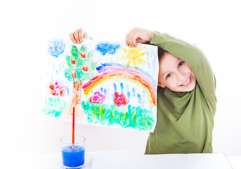 Image showing Happy boy presenting his painting