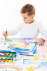 Image showing Casual schoolboy painting