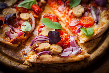 Image showing Homemade pizza with dried tomatoes and salami 