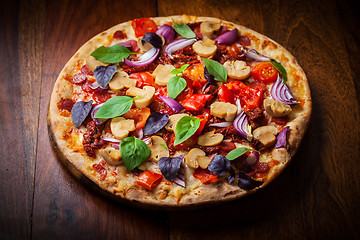 Image showing Homemade pizza with dried tomatoes and salami 