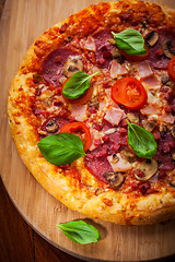 Image showing Traditional pizza with salami and mushrooms