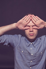 Image showing man covering face with his both hands