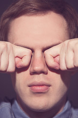 Image showing man covering face with his both hands