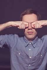 Image showing man covering face with his both hands
