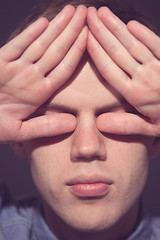 Image showing man covering face with his both hands