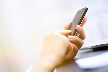 Image showing Close up of a woman using smartphone