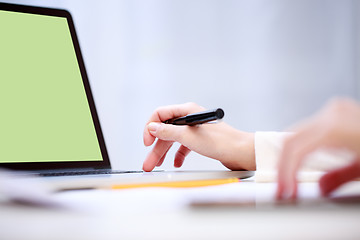 Image showing Woman analyzing something at laptop.