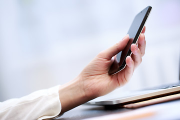 Image showing Close up of a woman using smartphone