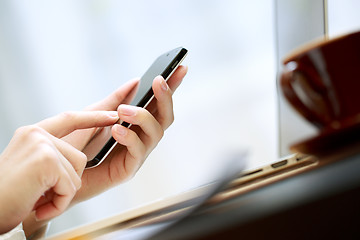 Image showing Close up of a woman using smartphone